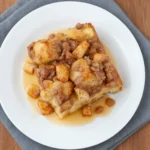 Overnight Apple Crisp Casserole 2 Overhead view of Overnight Apple Crisp Casserole on a plate over slate linen