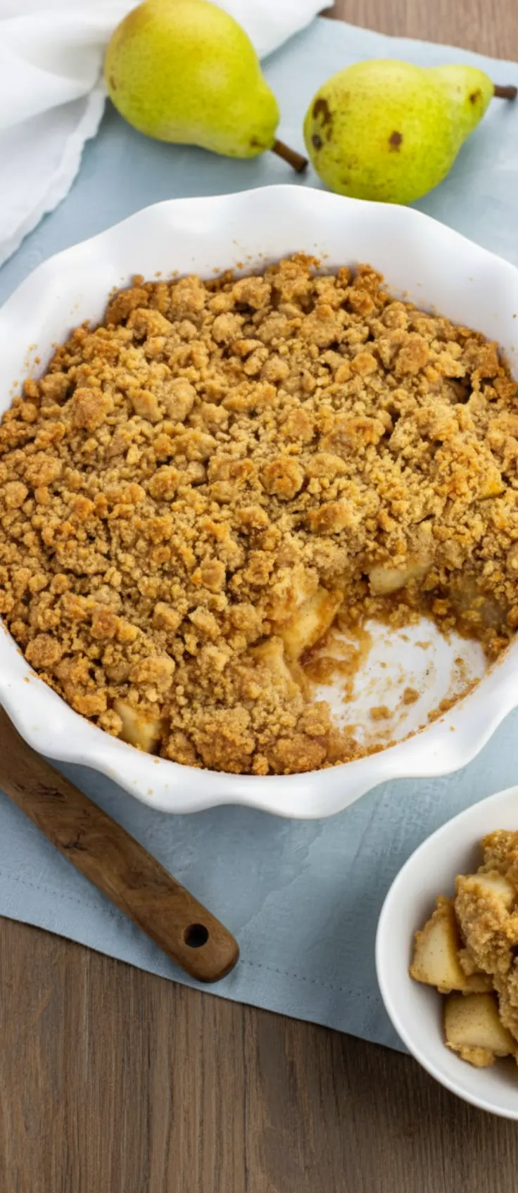 Layered spiced pear crumble in glass jars with golden oat topping