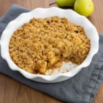 Spiced pear crumble jars ready to serve with caramel drizzle