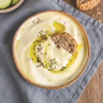 3-ingredient cottage cheese protein dip in bowl with pesto swirl and lemon