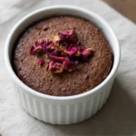 Stirring healthy chocolate mug cake batter in a mug