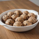No-Bake Cookie Dough Bites (Healthy and Edible) 2 Hand holding a healthy cookie dough bite with chocolate chips